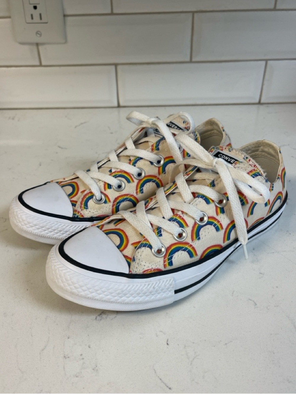 Converse Chuck Taylor All Star Low Top sneakers iall-over rainbow print.